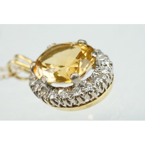 22 - Citrine and diamond unmarked yellow and white gold set pendant necklace, the oval mixed cut citrine ... 