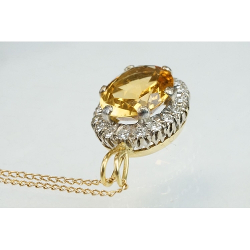 22 - Citrine and diamond unmarked yellow and white gold set pendant necklace, the oval mixed cut citrine ... 