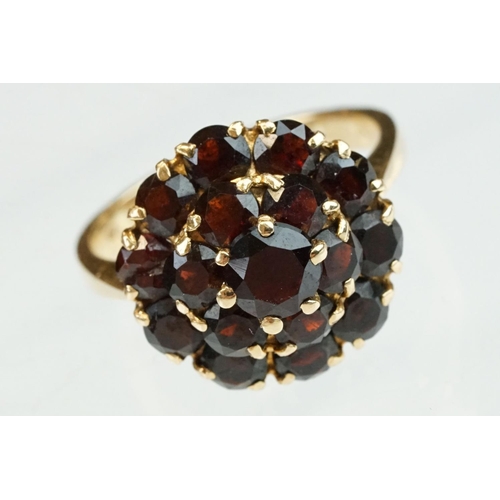 23 - Garnet 18ct yellow gold three tier cluster ring, sixteen round mixed cut garnets, claw set, diameter... 