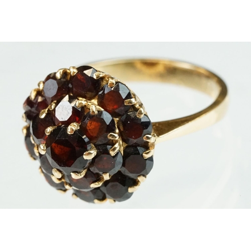 23 - Garnet 18ct yellow gold three tier cluster ring, sixteen round mixed cut garnets, claw set, diameter... 