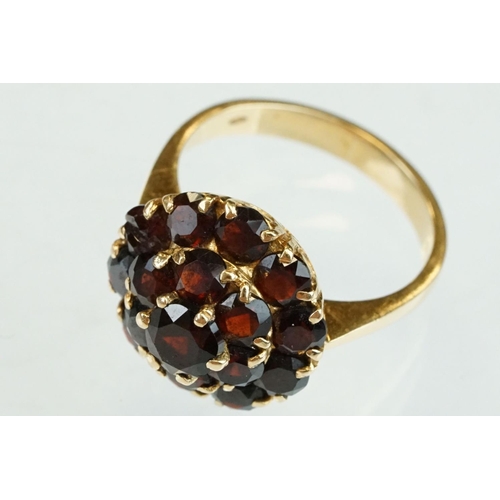 23 - Garnet 18ct yellow gold three tier cluster ring, sixteen round mixed cut garnets, claw set, diameter... 