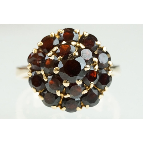 23 - Garnet 18ct yellow gold three tier cluster ring, sixteen round mixed cut garnets, claw set, diameter... 