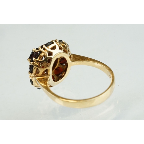 23 - Garnet 18ct yellow gold three tier cluster ring, sixteen round mixed cut garnets, claw set, diameter... 