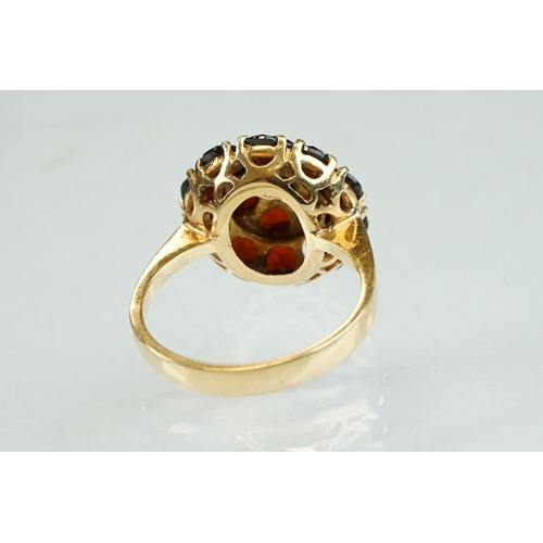 23 - Garnet 18ct yellow gold three tier cluster ring, sixteen round mixed cut garnets, claw set, diameter... 