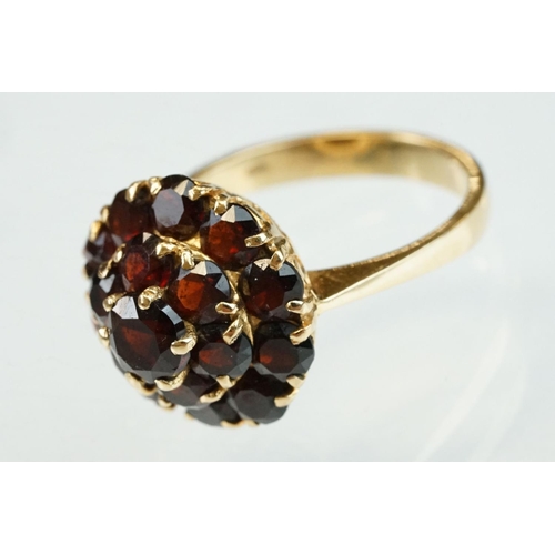 23 - Garnet 18ct yellow gold three tier cluster ring, sixteen round mixed cut garnets, claw set, diameter... 