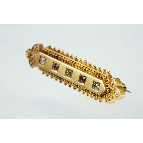 29 - Late 19th century Etruscan revival diamond and ruby 15ct yellow gold brooch, three small old cut dia... 