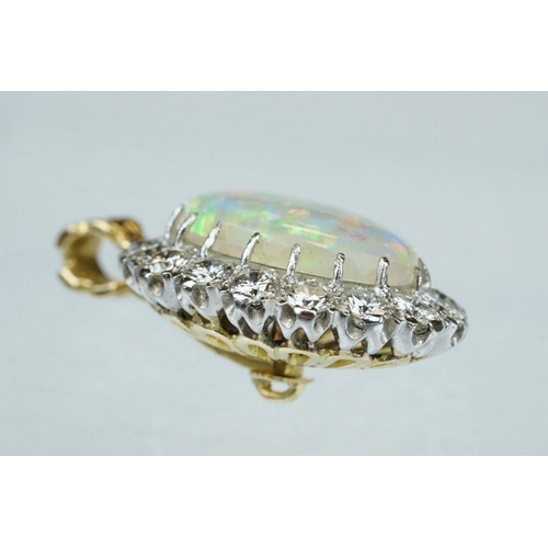 3 - Opal and diamond unmarked yellow and white gold set pendant, the oval cabochon cut opal displaying f... 