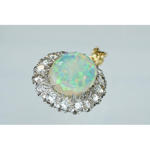 3 - Opal and diamond unmarked yellow and white gold set pendant, the oval cabochon cut opal displaying f... 