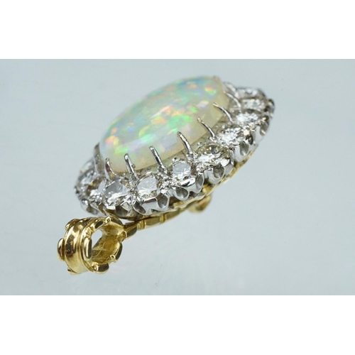 3 - Opal and diamond unmarked yellow and white gold set pendant, the oval cabochon cut opal displaying f... 