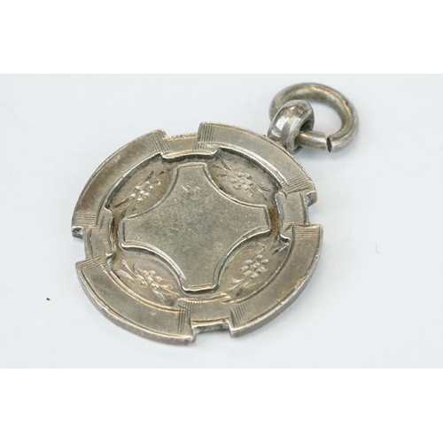 389A - Two silver fobs, a silver fob watch, an enamelled silver fob watch (af) and a late Victorian silver ... 