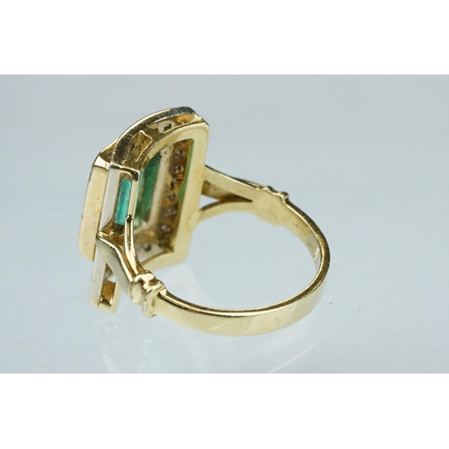 4 - Emerald and diamond unmarked yellow gold ring, the emerald cut emerald measuring approx 11mm x 7mm, ... 