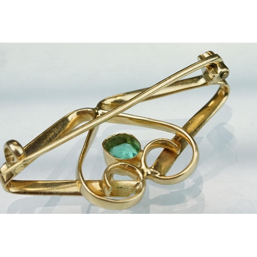 6 - Art Nouveau emerald unmarked yellow gold brooch, the central oval mixed cut emerald measuring approx... 