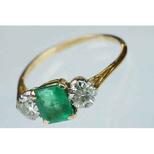 8 - Emerald and diamond 18ct yellow gold three stone ring,  the rectangular mixed cut emerald measuring ... 