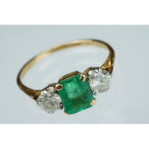 8 - Emerald and diamond 18ct yellow gold three stone ring,  the rectangular mixed cut emerald measuring ... 