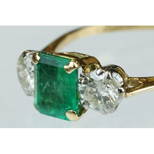 8 - Emerald and diamond 18ct yellow gold three stone ring,  the rectangular mixed cut emerald measuring ... 