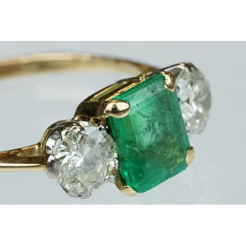 8 - Emerald and diamond 18ct yellow gold three stone ring,  the rectangular mixed cut emerald measuring ... 