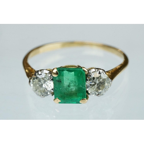 8 - Emerald and diamond 18ct yellow gold three stone ring,  the rectangular mixed cut emerald measuring ... 