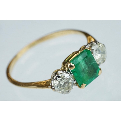 8 - Emerald and diamond 18ct yellow gold three stone ring,  the rectangular mixed cut emerald measuring ... 