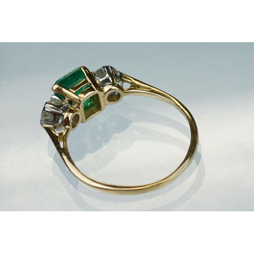 8 - Emerald and diamond 18ct yellow gold three stone ring,  the rectangular mixed cut emerald measuring ... 