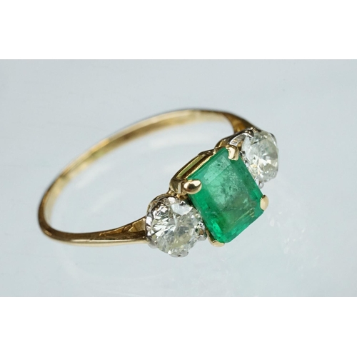 8 - Emerald and diamond 18ct yellow gold three stone ring,  the rectangular mixed cut emerald measuring ... 