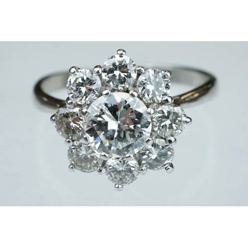 9 - Diamond platinum flower head cluster ring, the principal round brilliant cut diamond weighing approx... 