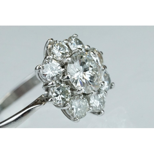 9 - Diamond platinum flower head cluster ring, the principal round brilliant cut diamond weighing approx... 