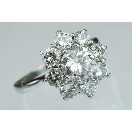 9 - Diamond platinum flower head cluster ring, the principal round brilliant cut diamond weighing approx... 