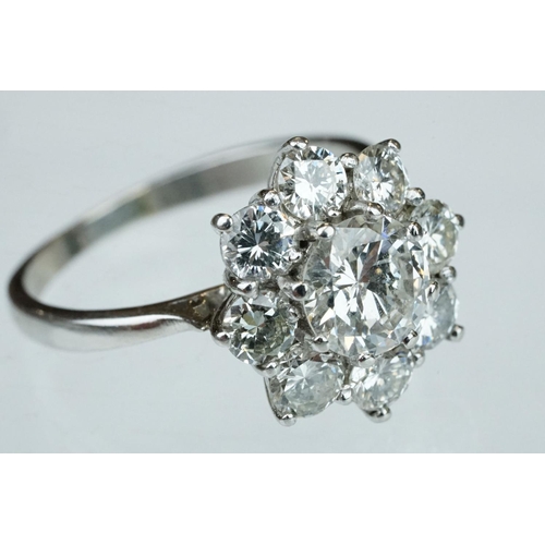 9 - Diamond platinum flower head cluster ring, the principal round brilliant cut diamond weighing approx... 