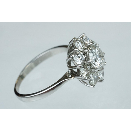 9 - Diamond platinum flower head cluster ring, the principal round brilliant cut diamond weighing approx... 