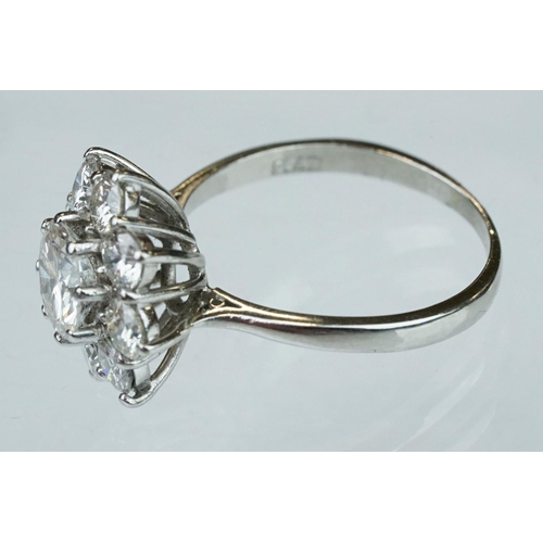 9 - Diamond platinum flower head cluster ring, the principal round brilliant cut diamond weighing approx... 