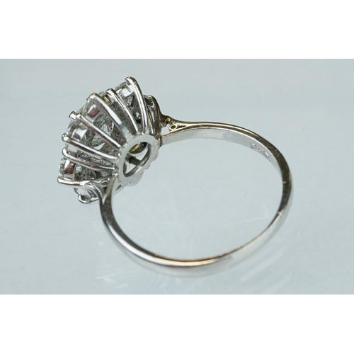 9 - Diamond platinum flower head cluster ring, the principal round brilliant cut diamond weighing approx... 