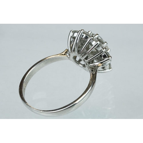 9 - Diamond platinum flower head cluster ring, the principal round brilliant cut diamond weighing approx... 