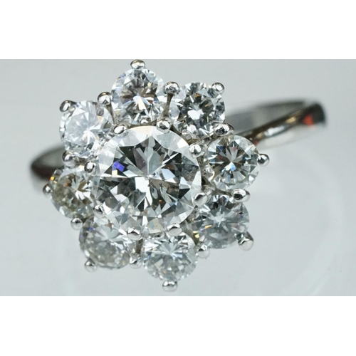 9 - Diamond platinum flower head cluster ring, the principal round brilliant cut diamond weighing approx... 