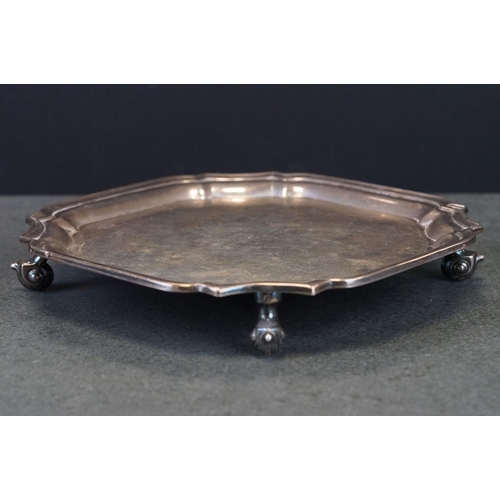 411 - Silver salver, octagonal form, plain polished, Chippendale border, raised on four scroll feet, maker... 