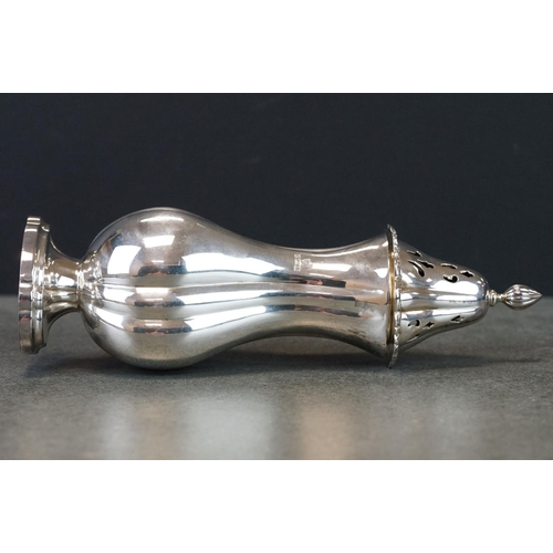 424 - Silver sugar caster, baluster form raised on scalloped oval foot, cast floral and foliate scroll bor... 