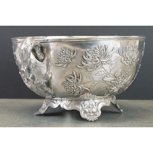 427 - White metal twin handled bowl raised on four feet, the handles modelled as branches, the bowl with c... 