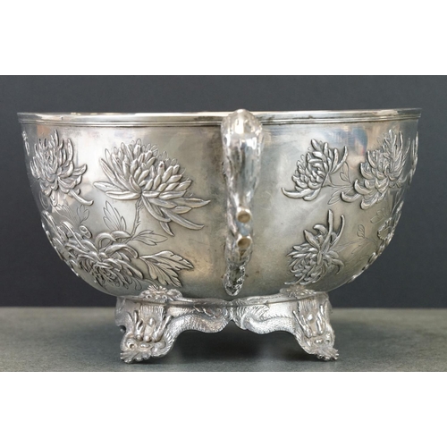 427 - White metal twin handled bowl raised on four feet, the handles modelled as branches, the bowl with c... 