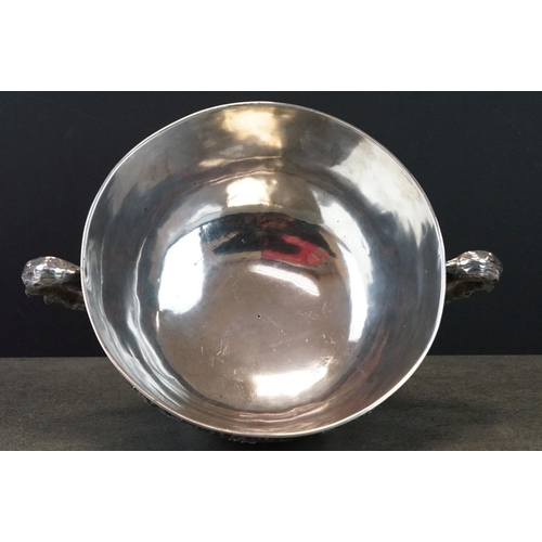 427 - White metal twin handled bowl raised on four feet, the handles modelled as branches, the bowl with c... 