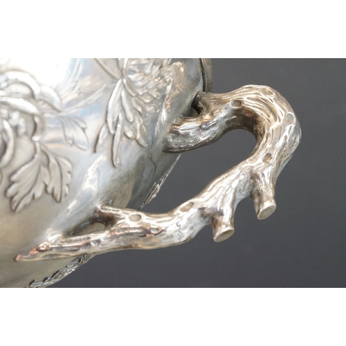 427 - White metal twin handled bowl raised on four feet, the handles modelled as branches, the bowl with c... 