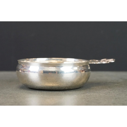 428 - George V silver porringer, plain polished bowl, pieced handle with crest, makers William Comyns & So... 