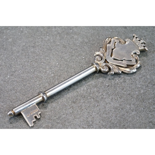 439 - Silver key in original case, blank cartouche, c with cast foliate scroll surround, crown surmount, m... 