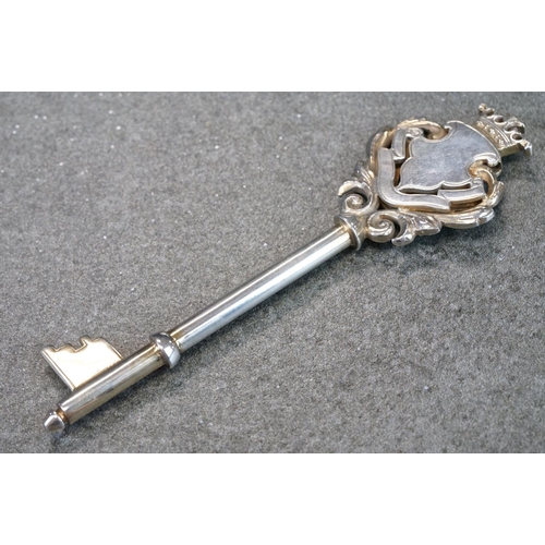 439 - Silver key in original case, blank cartouche, c with cast foliate scroll surround, crown surmount, m... 