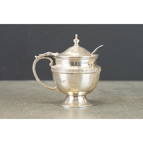 447 - Silver milk jug raised on four feet, angular handle, makers F H Adams & Co, Birmingham 1928, height ... 