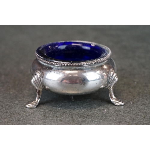 448 - Silver mustard pot and pepper pot, pierced form with geometric decoration, blue glass liners, makers... 