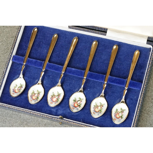 452 - Six enamelled silver gilt demitasse spoons, the bowls with white enamel decorated with fruit and lea... 