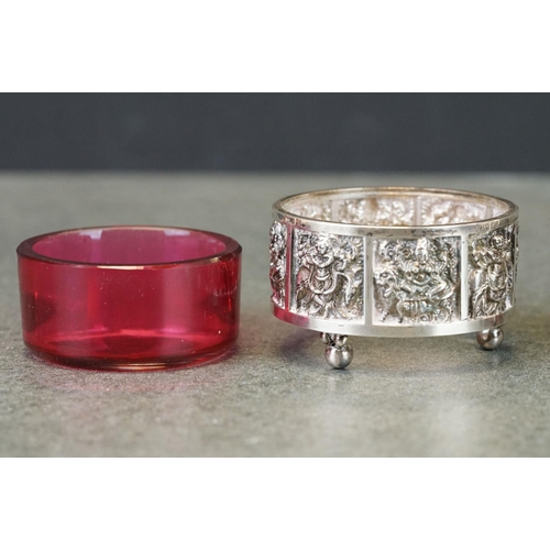 455 - Pair of Victorian silver open salt cellars, cranberry glass liners, repeating panels depicting figur... 