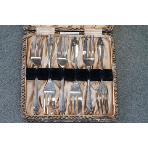 456 - Cased set of six Edwardian silver coffee spoons with matching sugar tongs, cast foliate decoration i... 