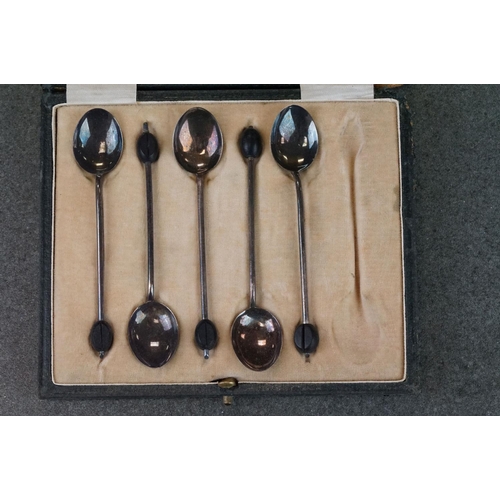 456 - Cased set of six Edwardian silver coffee spoons with matching sugar tongs, cast foliate decoration i... 