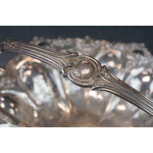 460 - Silver swing handled pedestal bowl, cast foliate scroll border, repoussé tapered panels with engrave... 