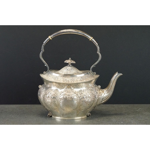 465 - Edwardian silver spirit kettle, the teapot with repoussé floral and foliate decoration throughout, h... 